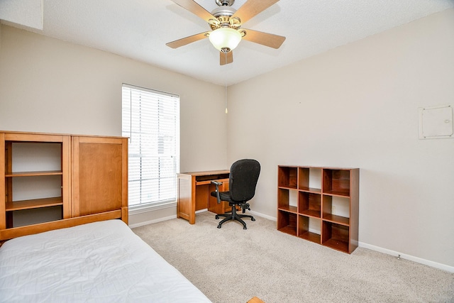 bedroom featuring baseboards, carpet flooring, and a ceiling fan