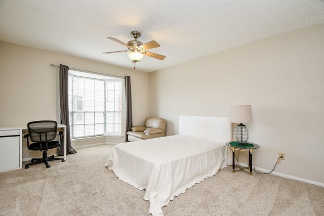 bedroom with carpet floors, a ceiling fan, and baseboards