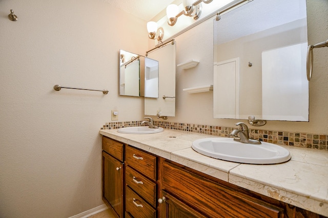 bathroom with double vanity and a sink