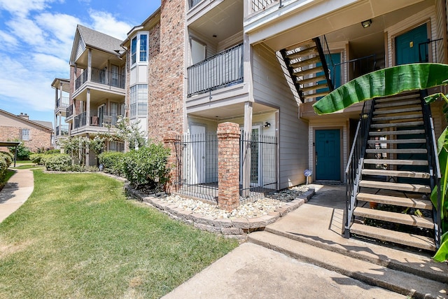 view of property with stairway and fence