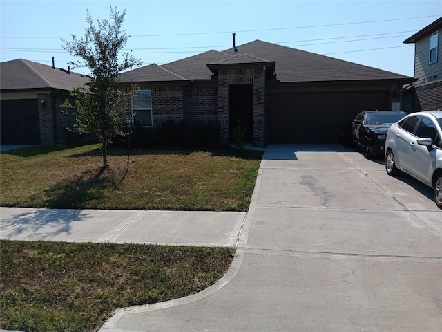ranch-style home with a garage, brick siding, driveway, roof with shingles, and a front yard