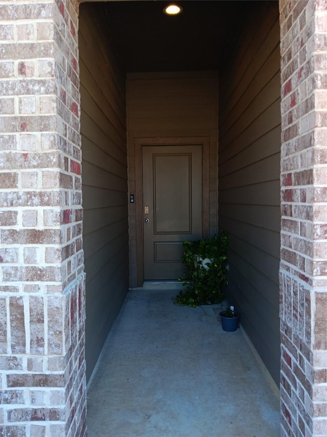 entrance to property with brick siding