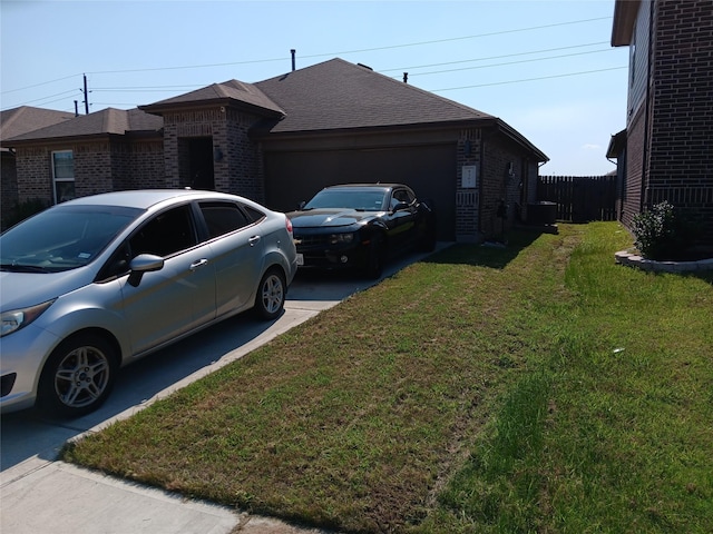 view of side of home featuring brick siding, a yard, a shingled roof, an attached garage, and driveway