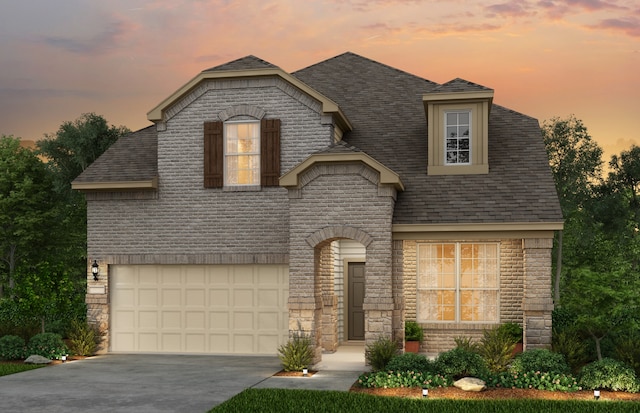 french country style house featuring a garage