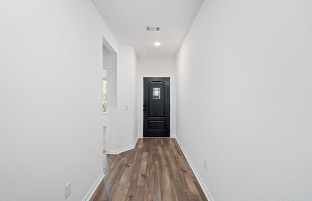 hallway with dark hardwood / wood-style floors