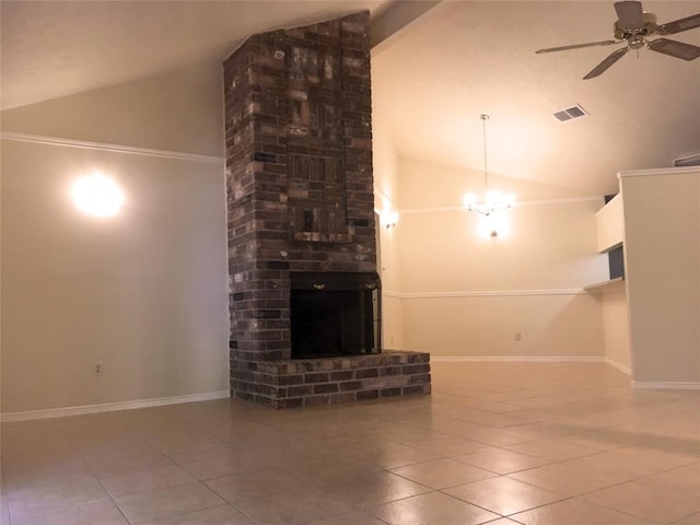 unfurnished living room with a fireplace, brick wall, ceiling fan with notable chandelier, and tile patterned floors