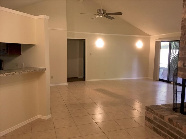 spare room with ceiling fan, high vaulted ceiling, and light tile patterned floors