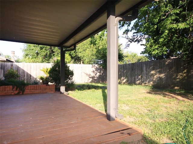 wooden terrace with a lawn