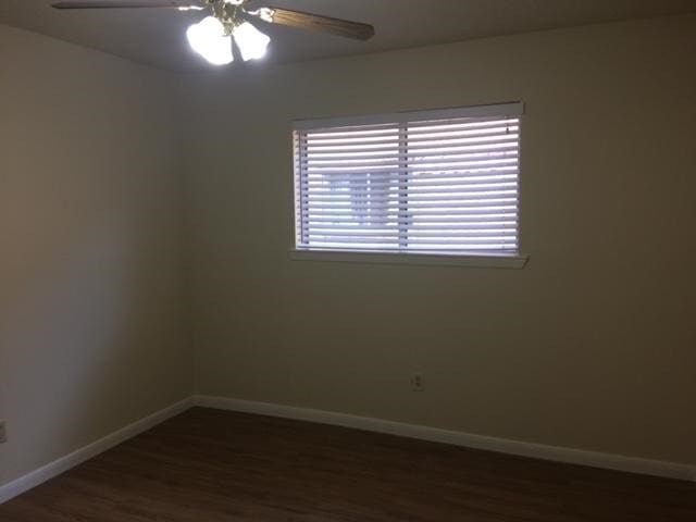 spare room with ceiling fan and hardwood / wood-style flooring