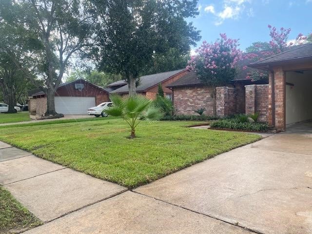 view of property exterior with a garage and a yard