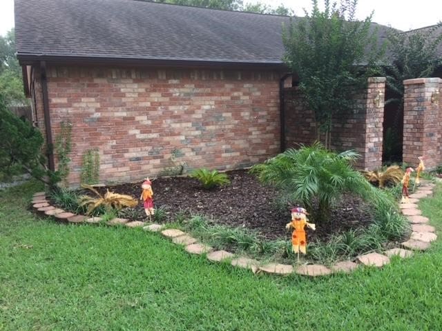 view of side of home featuring a yard