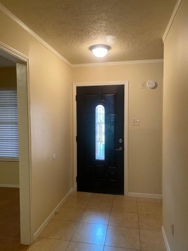 foyer entrance featuring light tile patterned floors, crown molding, and a textured ceiling