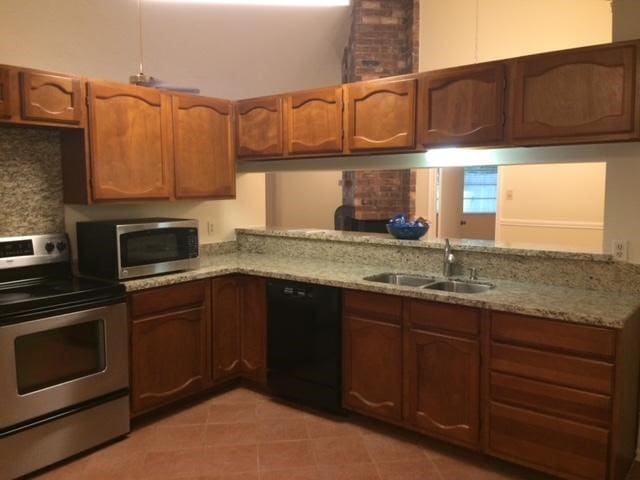 kitchen featuring sink, range, light stone counters, dishwasher, and kitchen peninsula