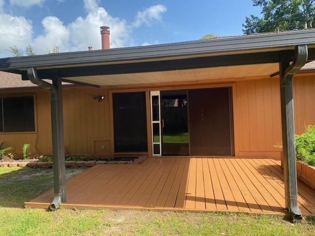 back of property with a wooden deck