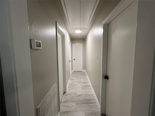 hall featuring light tile patterned floors