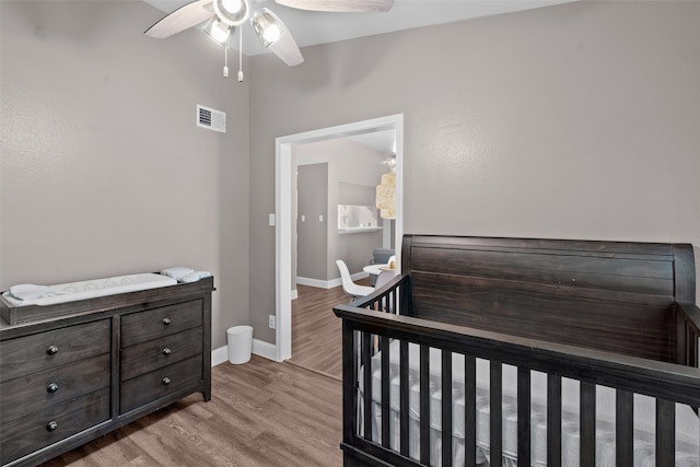 bedroom with light hardwood / wood-style flooring and ceiling fan