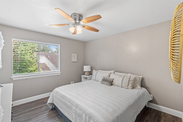 bedroom with ceiling fan and dark hardwood / wood-style flooring