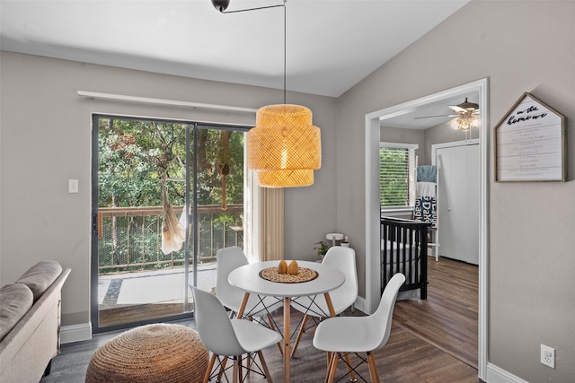 dining area featuring ceiling fan, dark hardwood / wood-style floors, and lofted ceiling