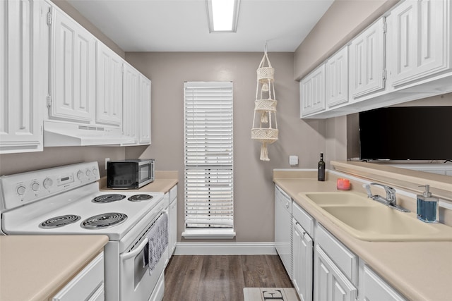 kitchen featuring dark wood-type flooring, hanging light fixtures, white cabinetry, sink, and white appliances