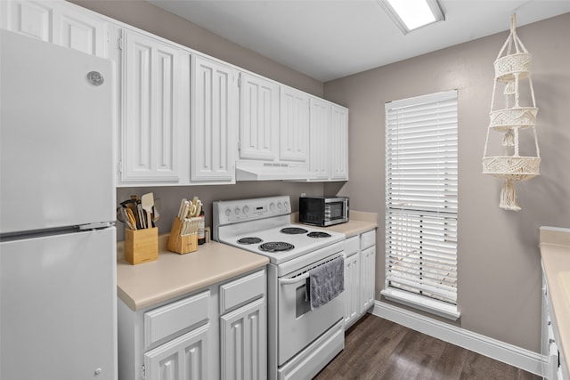 kitchen with custom range hood, white appliances, dark hardwood / wood-style floors, white cabinetry, and hanging light fixtures