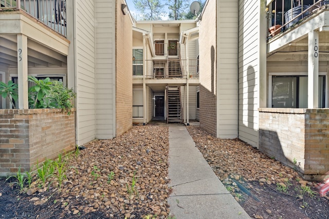 view of exterior entry with a balcony