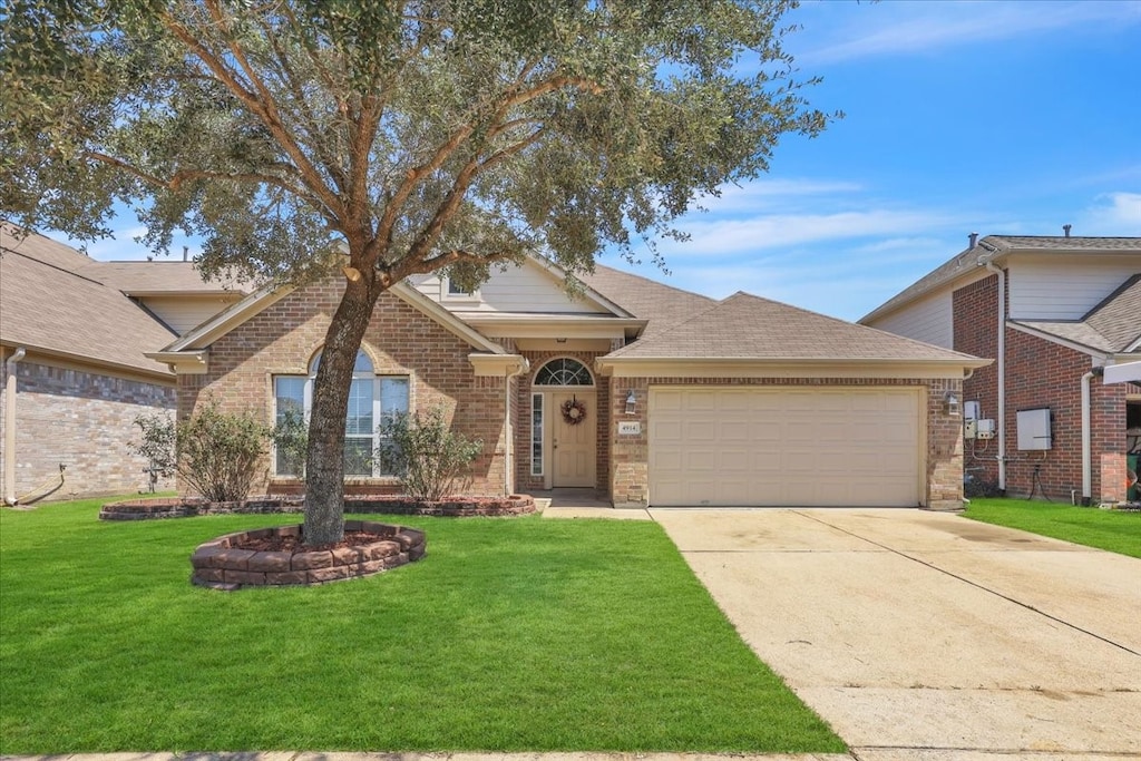 view of front of house with a garage and a front lawn