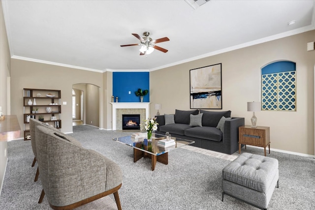 living room featuring ceiling fan, carpet, and ornamental molding