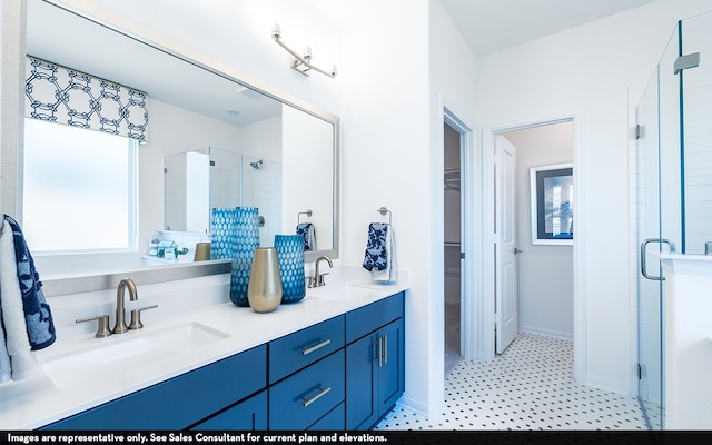 bathroom with double vanity, tile patterned floors, and a shower with shower door