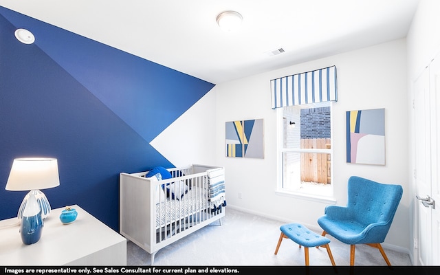 carpeted bedroom featuring a crib