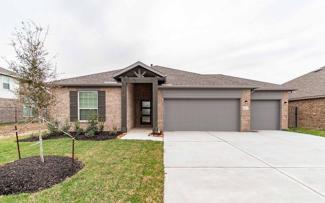 ranch-style home with a garage and a front lawn