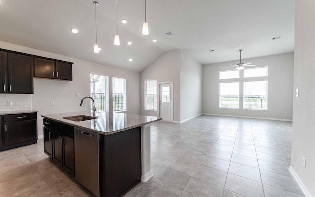 kitchen with sink, dishwasher, light stone counters, dark brown cabinetry, and a center island with sink