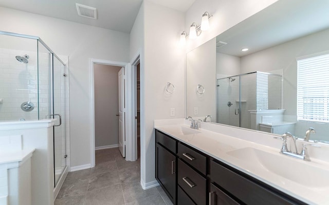 bathroom featuring walk in shower, tile patterned floors, and vanity