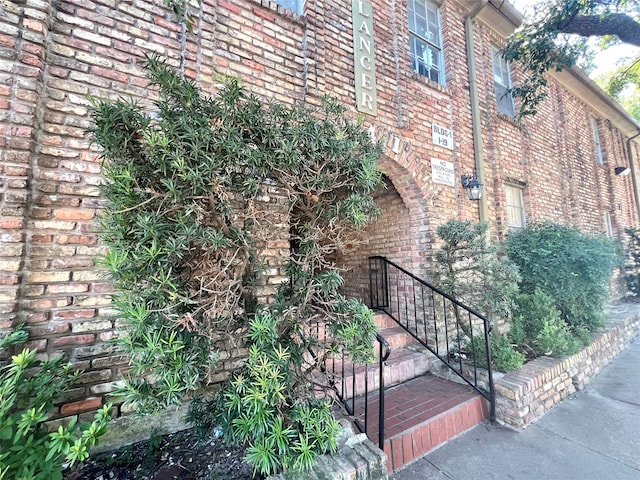 view of side of property with brick siding