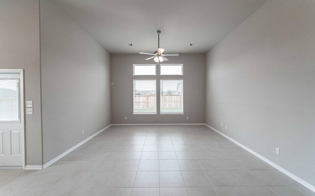 spare room featuring light tile patterned flooring and ceiling fan