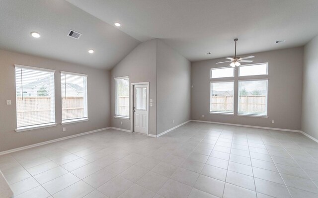 unfurnished room with ceiling fan, lofted ceiling, and light tile patterned floors