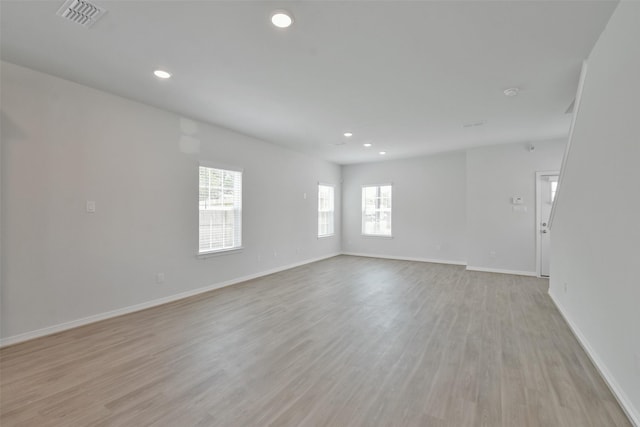 spare room with light hardwood / wood-style flooring