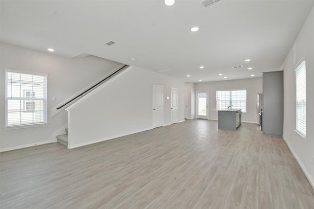 unfurnished living room with light hardwood / wood-style floors