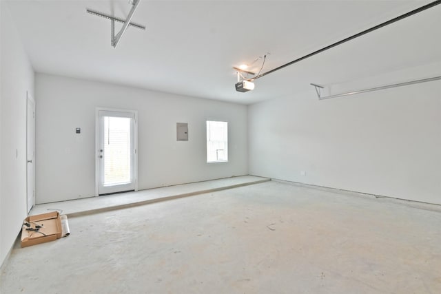 garage with a garage door opener and electric panel