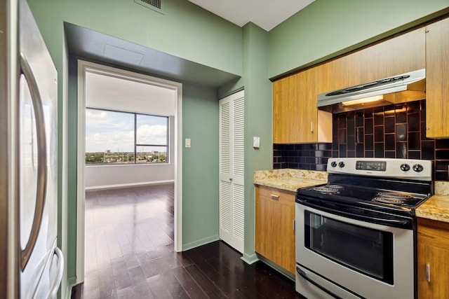 kitchen with decorative backsplash, dark wood-type flooring, stainless steel range with electric cooktop, refrigerator, and light stone countertops