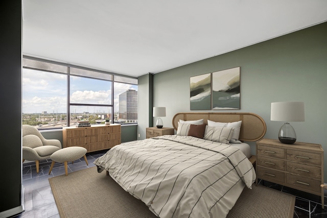 tiled bedroom featuring floor to ceiling windows