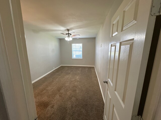 carpeted empty room featuring ceiling fan