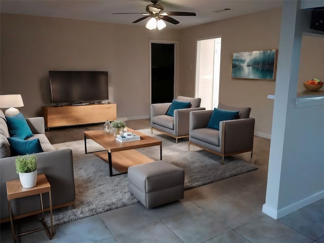 tiled living room featuring ceiling fan