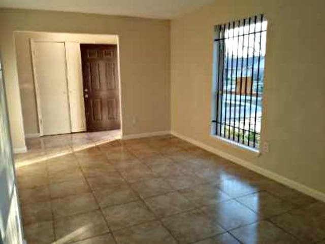 empty room with tile patterned flooring