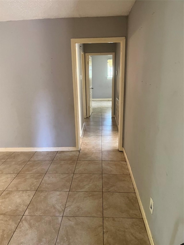 corridor featuring light tile patterned floors