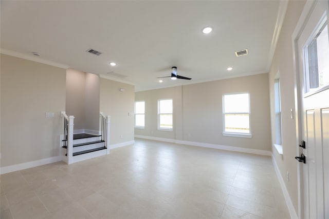 spare room featuring ceiling fan, crown molding, and a healthy amount of sunlight