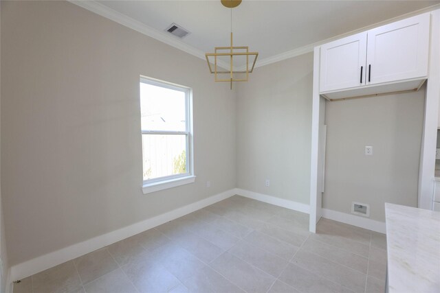 unfurnished dining area featuring light tile patterned flooring and crown molding