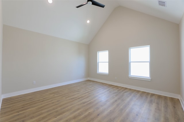 unfurnished room with high vaulted ceiling and light hardwood / wood-style floors