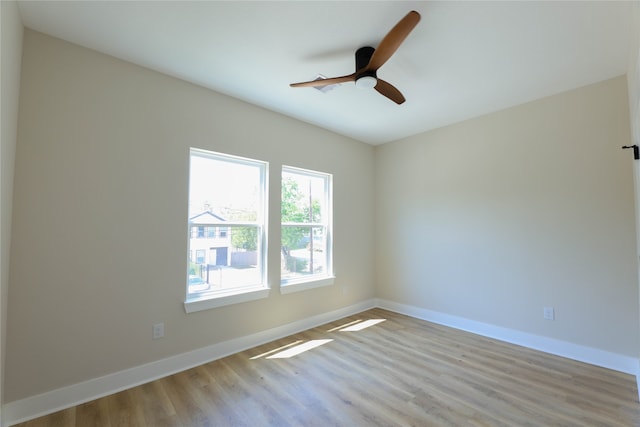 spare room with light wood-type flooring and ceiling fan