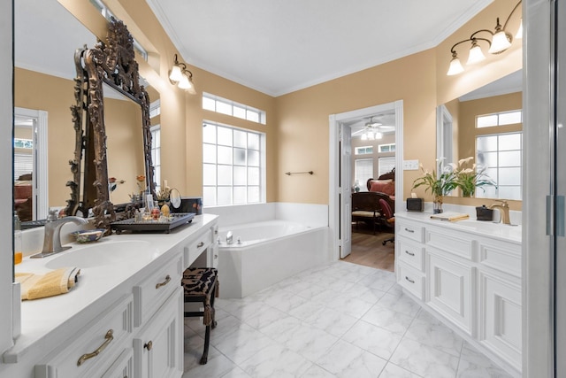 full bath with connected bathroom, ornamental molding, two vanities, a garden tub, and a sink