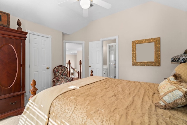 bedroom with vaulted ceiling, ceiling fan, and ensuite bathroom